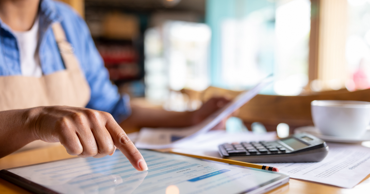 Business owner doing accounting at cafe