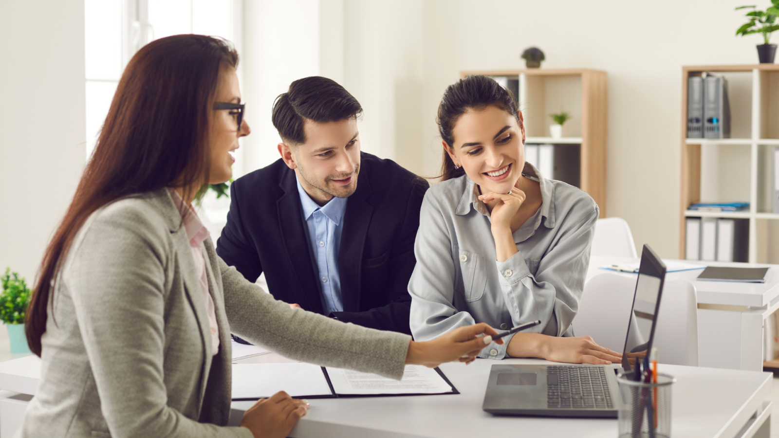 An image of a tax advisor meeting with her clients to review the latest changes in the capital gains tax and how it may impact their estate plan.